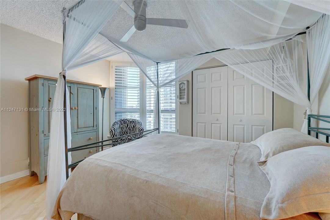 Bright guest room w/ custom closet. Peek at the ocean from the windows