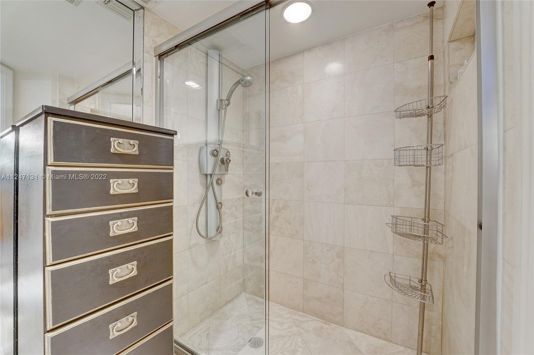 Separate marble shower in primary bathroom