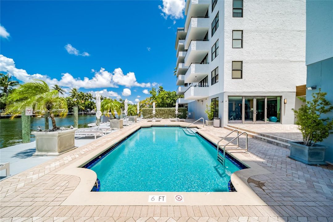 Pool area with Building where unit is located in background