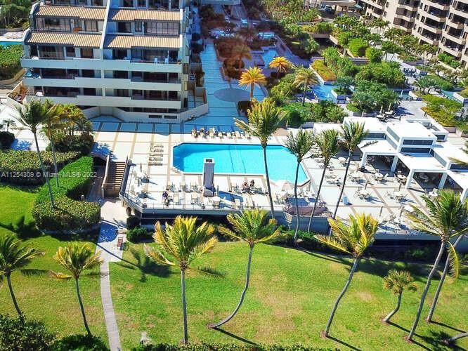 Aerial of beachfront pool, bar & grill and path to the beach.