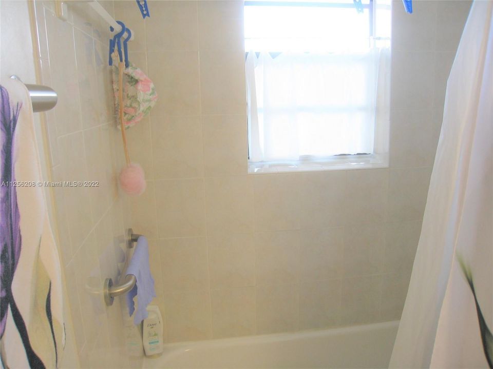 View of bath/shower interior; all light & bright