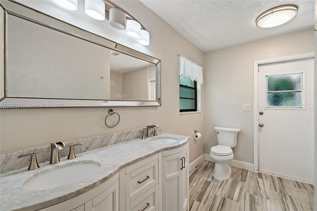 Master bathroom with dual vanities and shower.