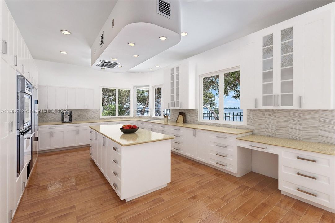 Kitchen with its spacious counters, large island and Wide Water Views.This Kitchen is Virtually Staged/Renovated.