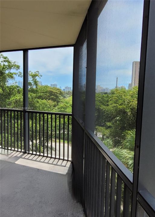 Large Balcony with view to the city and beautiful big treses forest.
