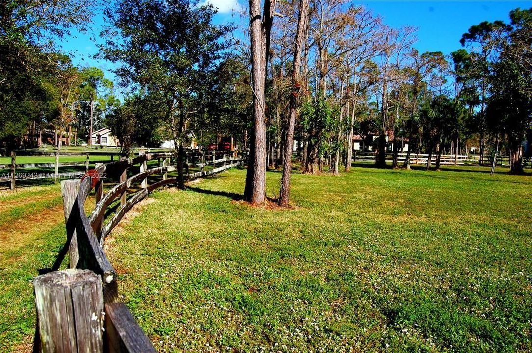 STABLE/BARN WITH FIVE 12 x 12 WALK-OUT STALLS WITH OPEN ACCESS TO OUTSIDE, AS WELL AS AN OFFICE/WORK ROOM ON 1.09 ACRES OF LAND THAT IS IRRIGATED AND FENCED.