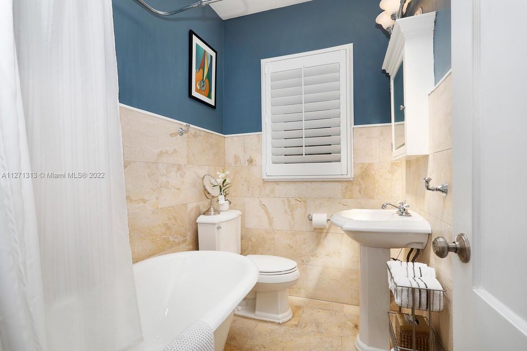 Guest bathroom with clawfoot tub exudes elegance, old world charm and ensures relaxation.
