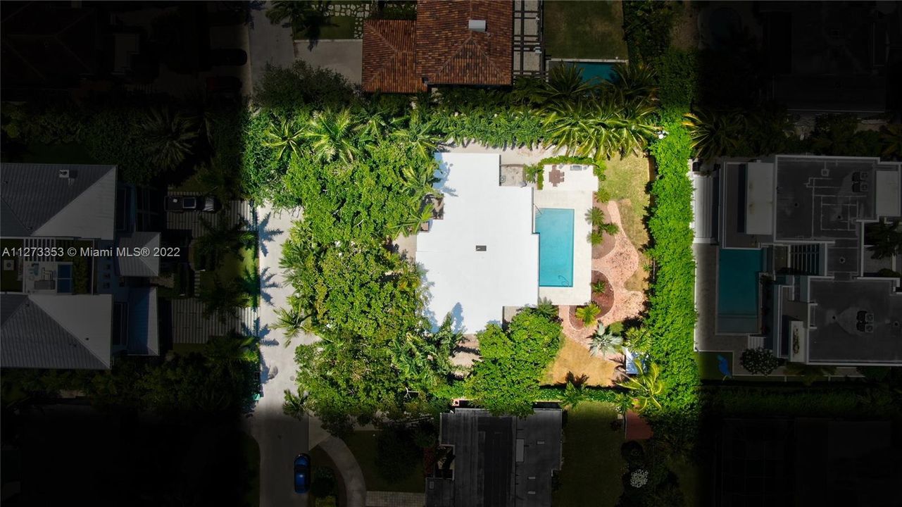 Aerial view of this single family home on over size 12,000 SF lot. 5/3 with pool
