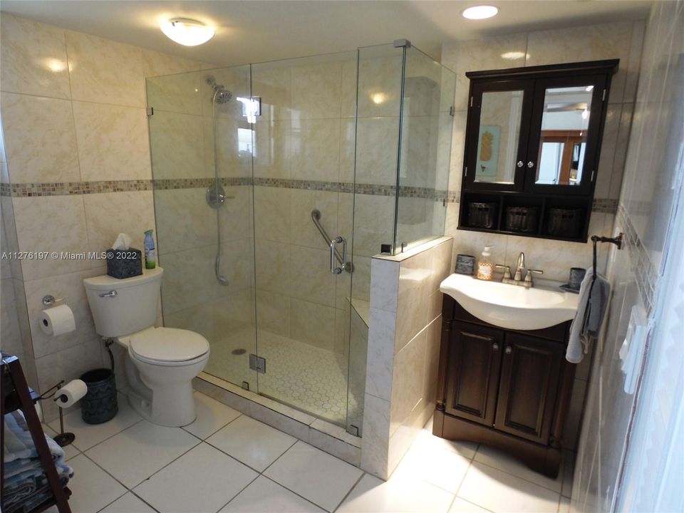 Full Bathroom with closet inside and equipped with towells.