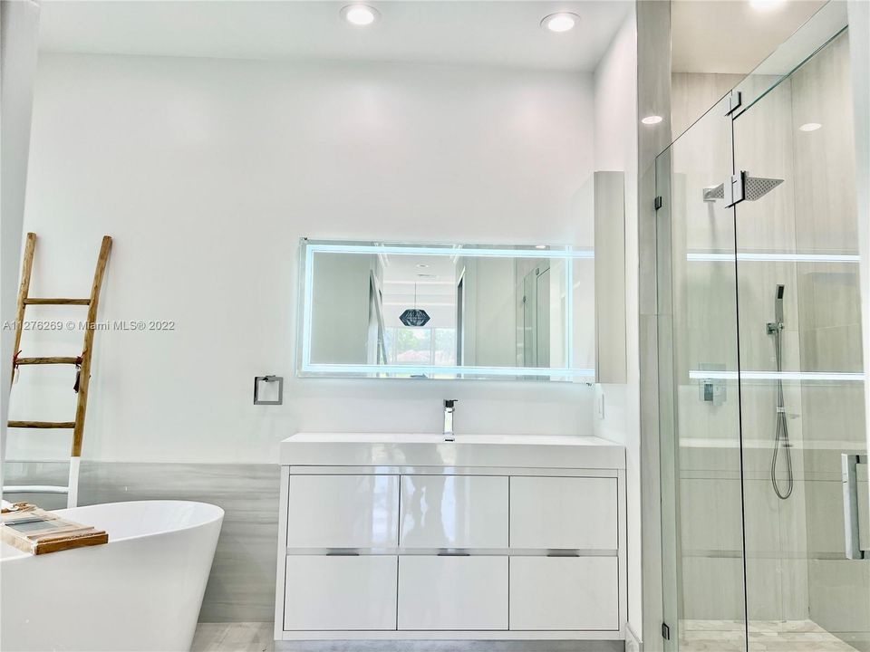 MASTER BATHROOM HER VANITY AND BATHTUB