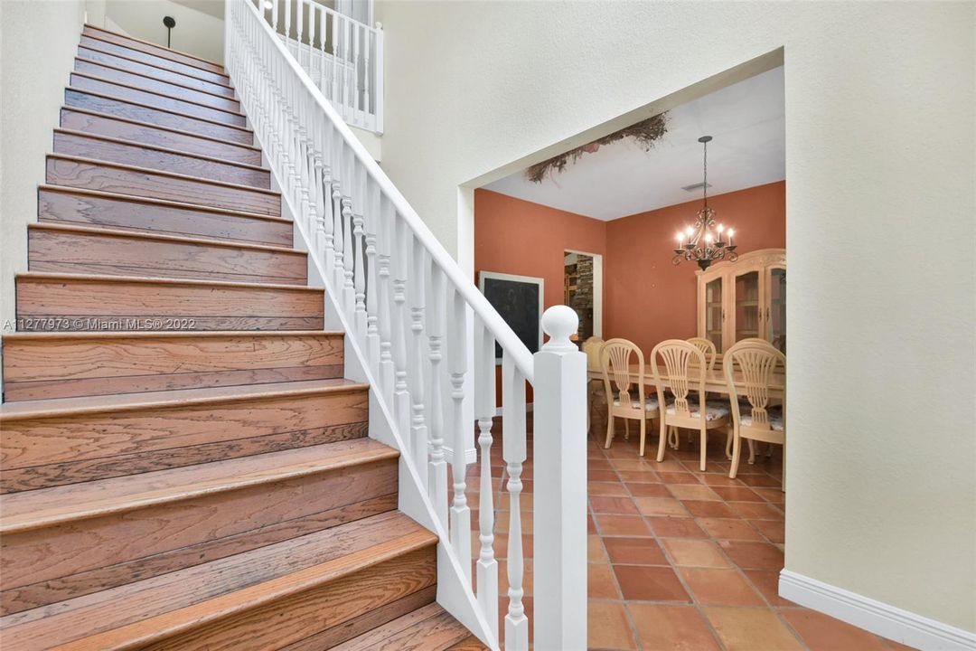 Stairs going to second floor view of dinning room.