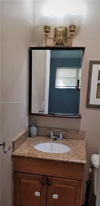 Primary bath vanity topped with a granite counter