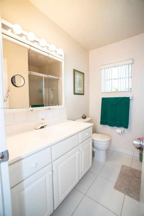 Guest bathroom has new toilet with softclose seat.  Step-in shower to the right.