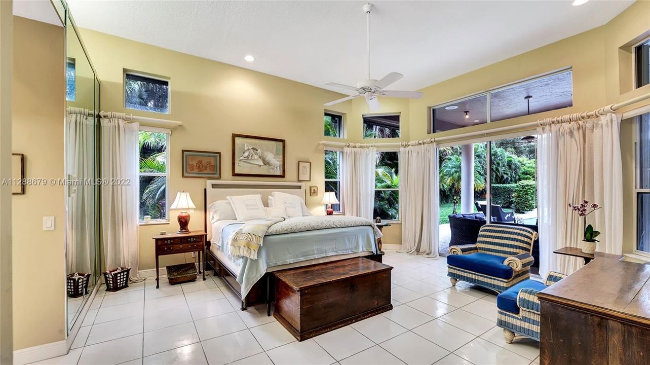 Master Suite & Ensuite overlooks the lavish outdoor space complete with a heated pool and hot tub.