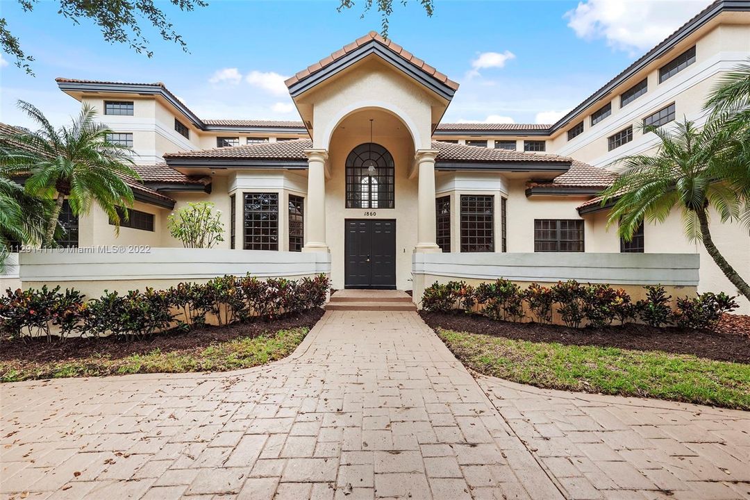 Front of home boast double doors and high ceilings