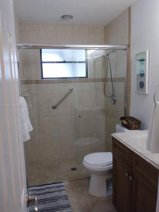 Full bathroom with shower and amenities