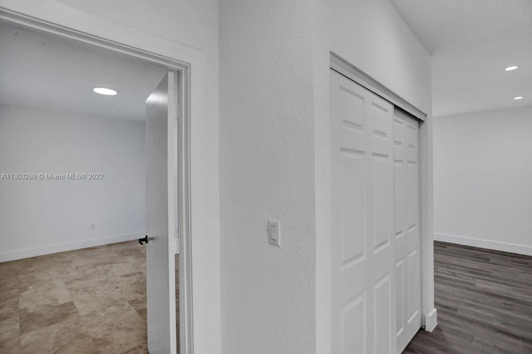 Partial view of the 4th bedroom and the short hallway leading to the versatile living space.