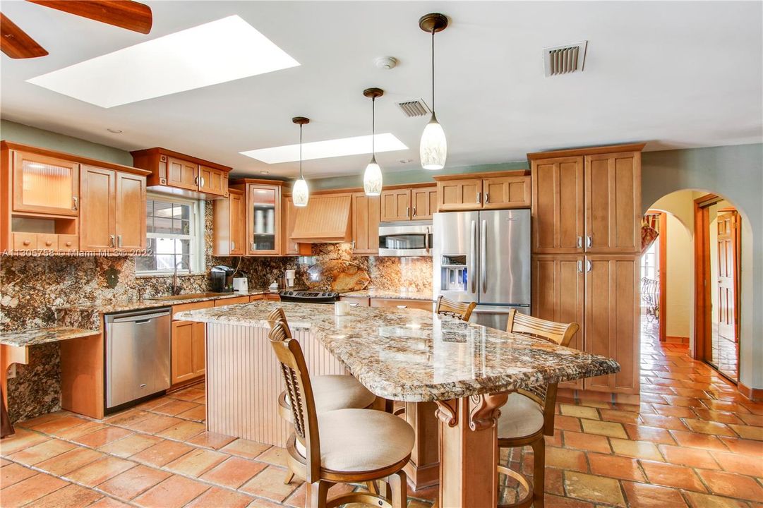 Custom Kitchen has it all. Newer stainless appliances, custom lighting, plenty of cabinets and a pantry.