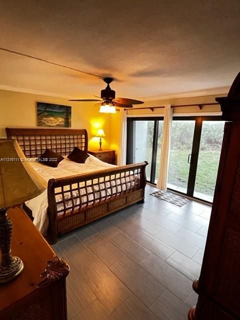 Main bedroom with impact glass sliders leading to small porch