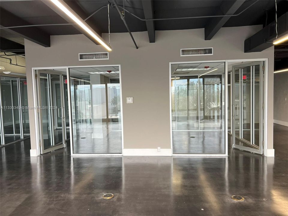 Office on left may receive a kitchenette and off on right will face overlooking the large "pit" cubicles open area.