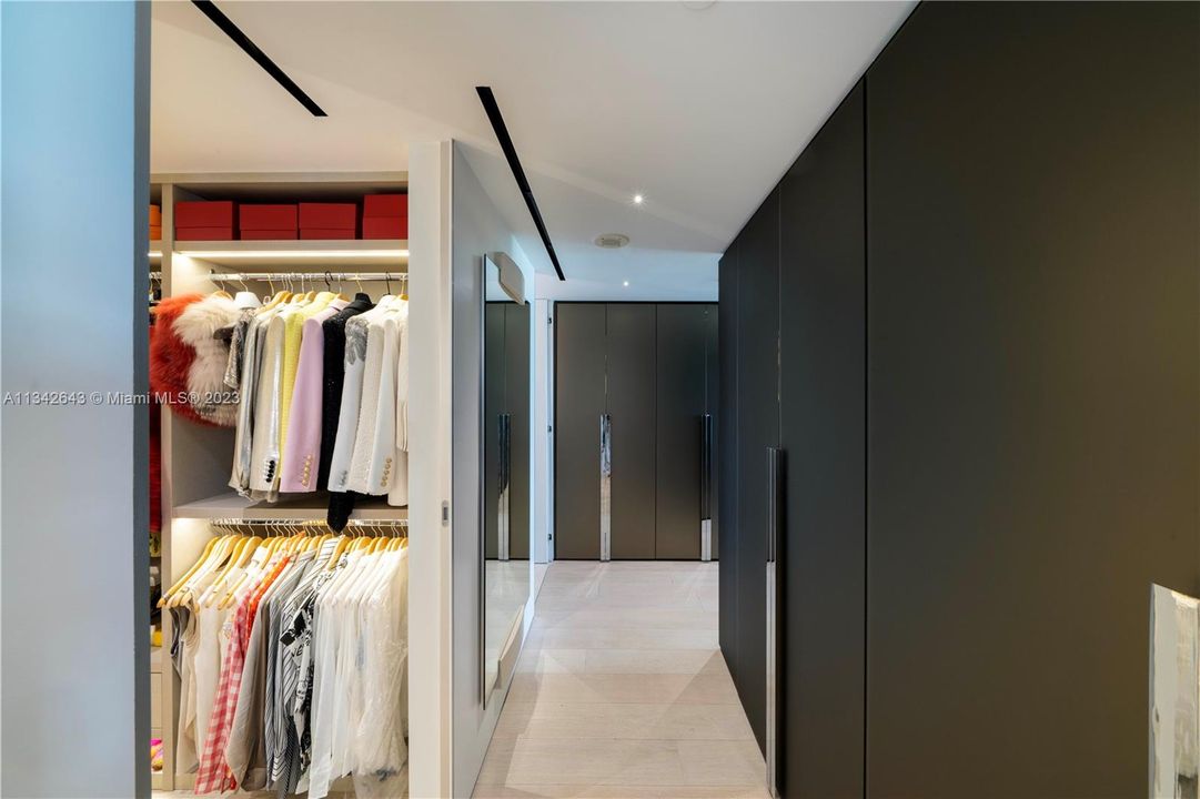 Custom walk-in closets with ample storage space.
