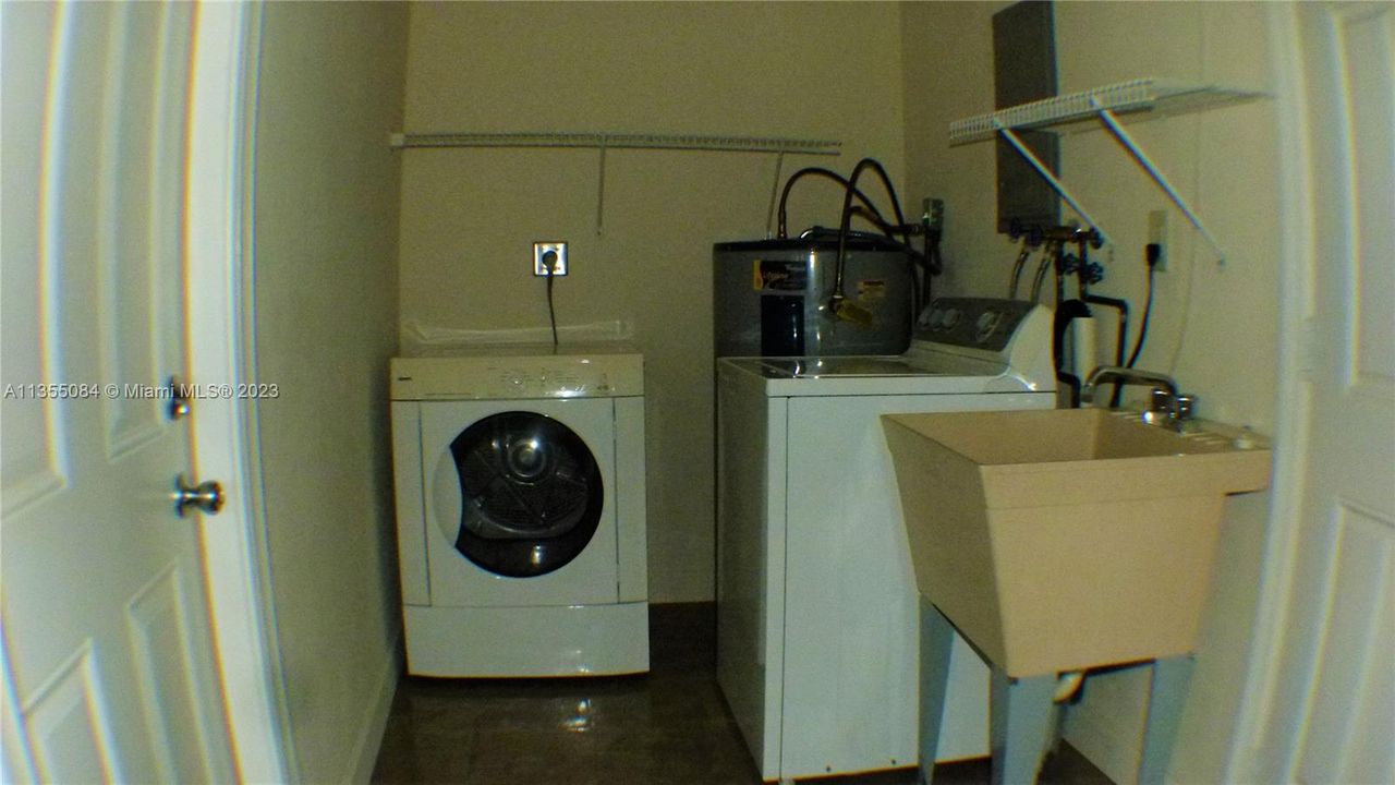 Full size Washer and Dryer; Sink Tub; Shelving; Water Heater in Garage.