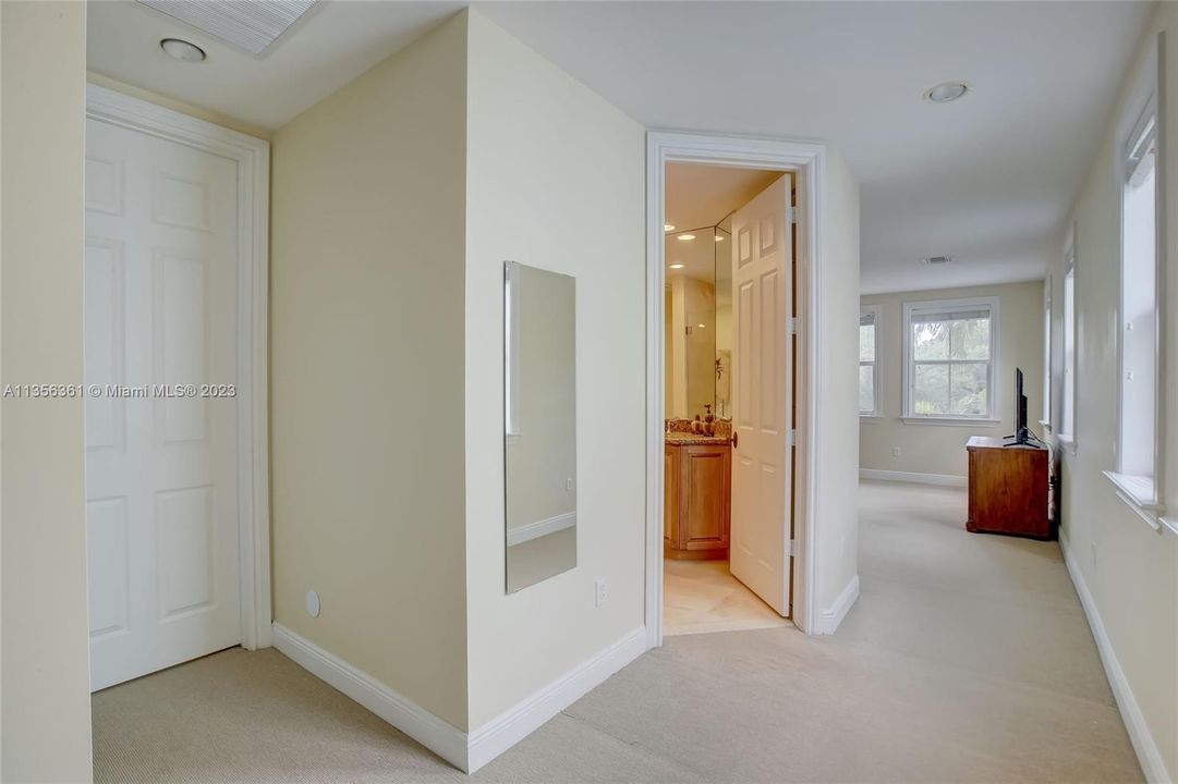 Entrance to Primary Bedroom w/ 2 closets to the left, en-suite bathroom and oversized bedroom w/ sitting area