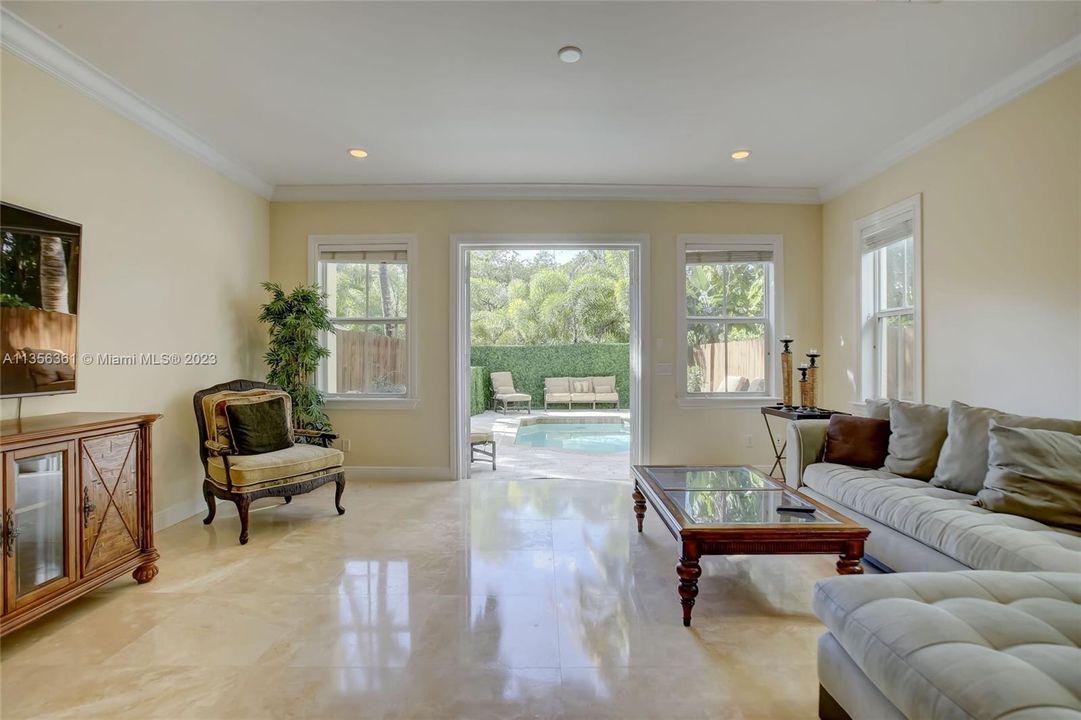 Marble floors and french doors in the great room, overlooking the private heated pool.