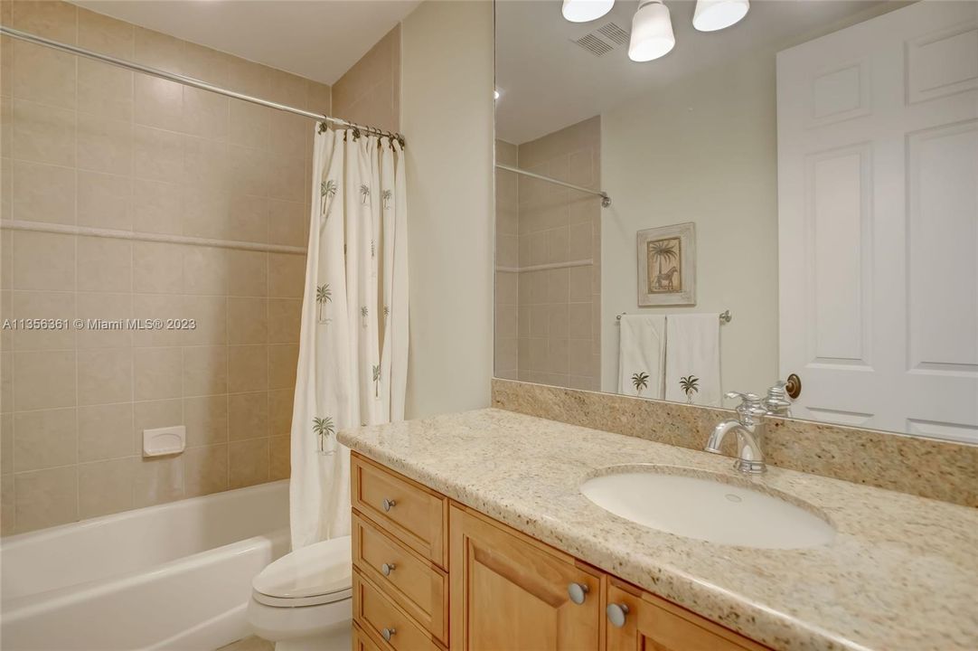 2nd level guest bathroom w/ combo tub / shower and granite vanity