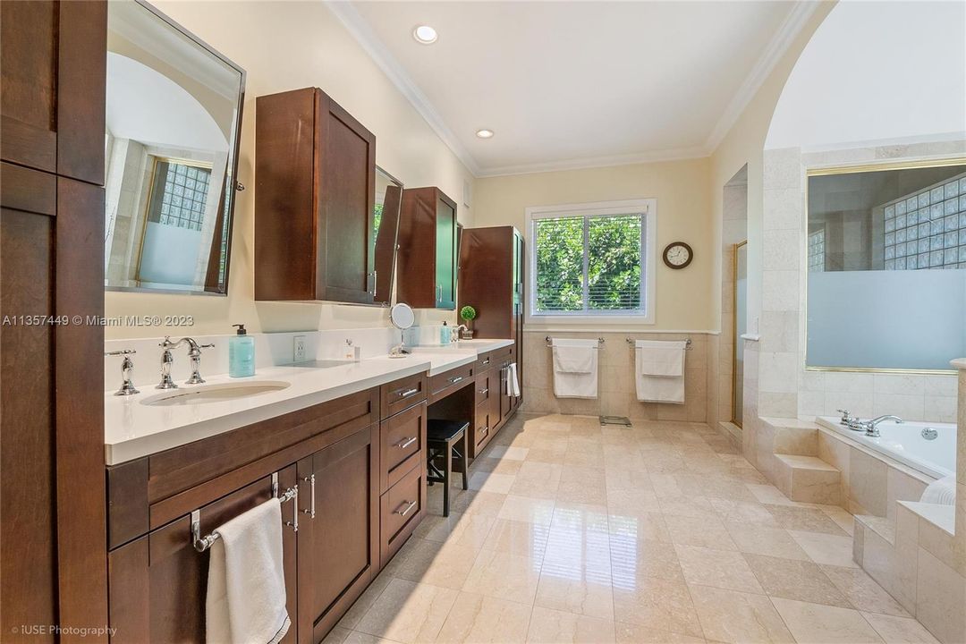 huge master bath with marble, custom cabinets, dual sinks