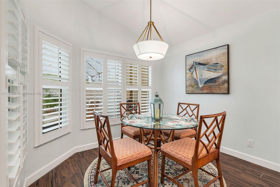 Breakfast nook with Plantation shutters overlooking pool patio area.