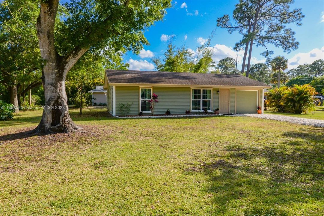 Lovely home on .26 acres with mature Oaks, Palms and Avocado Tree