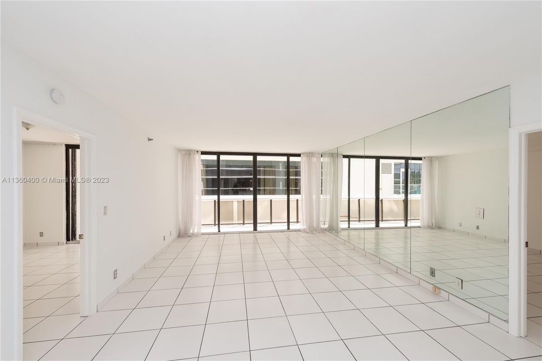 Spacious living and dining area with balcony access