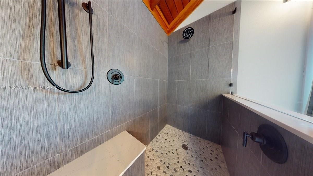 Dual shower heads, double sink vanity, separate water closet and linen closet