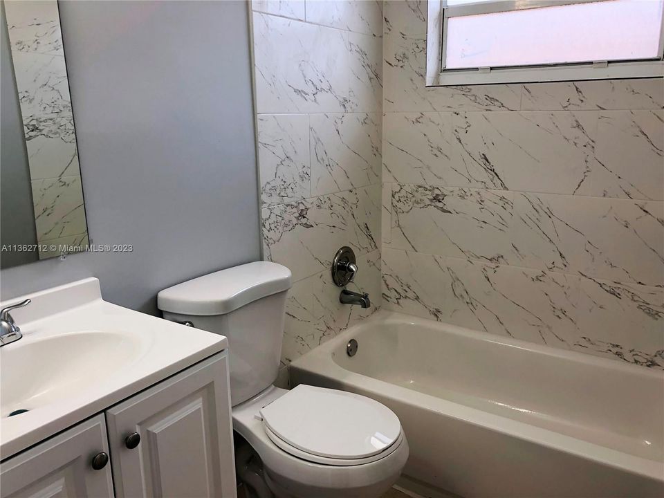 The bathroom features a combination shower & tub.