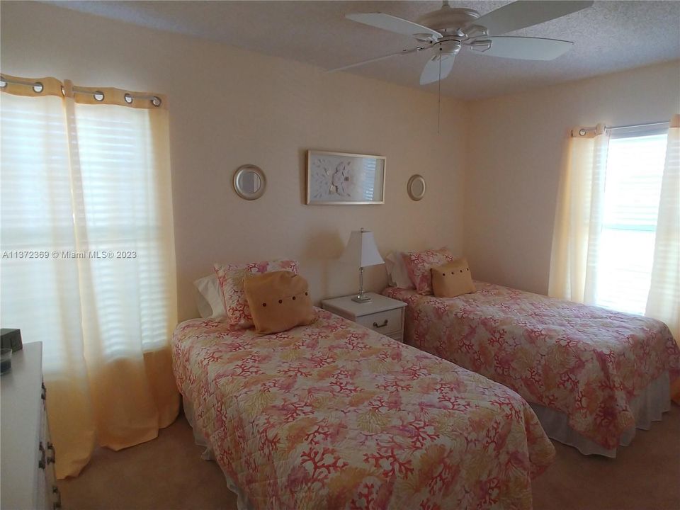 Twin Beds in the Guest room with 2 windows and walk in closet