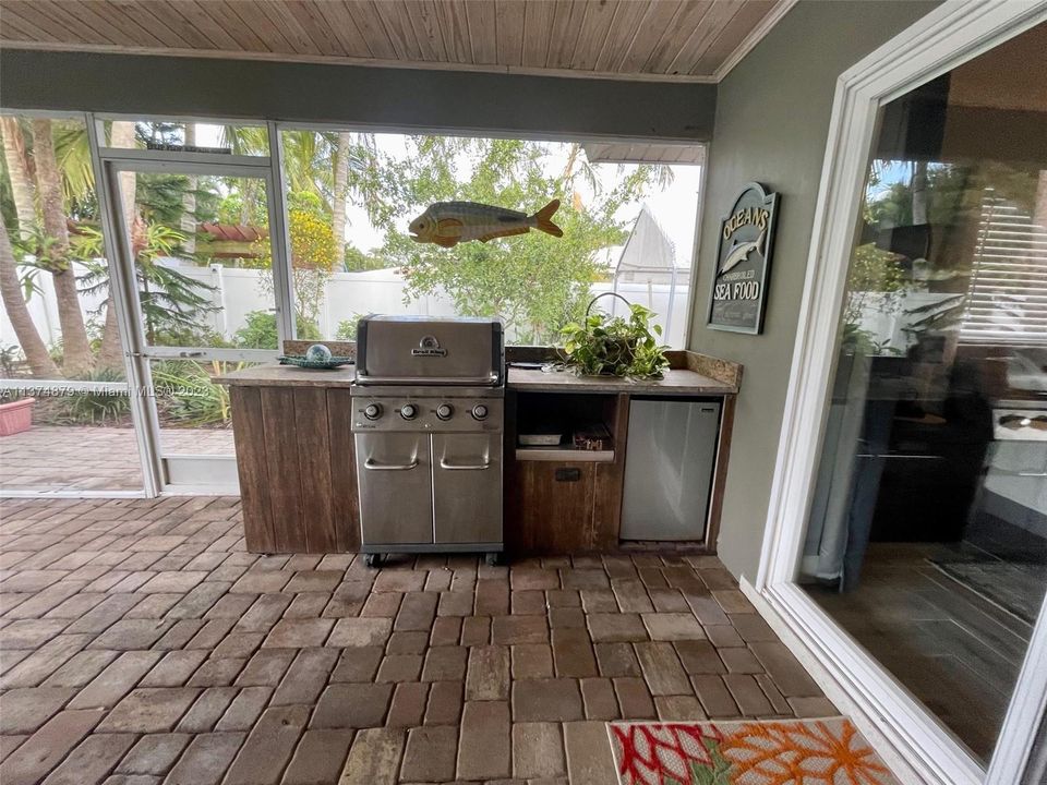 Ourdoor kitchen on covered patio.