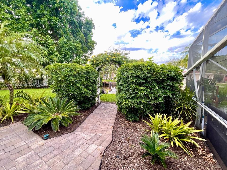 Lushly landscaped with fruit trees & variety of plants.