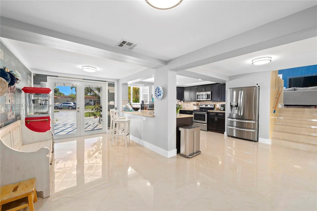 Stairs on the right go up to the main living room and informal Florida Room.