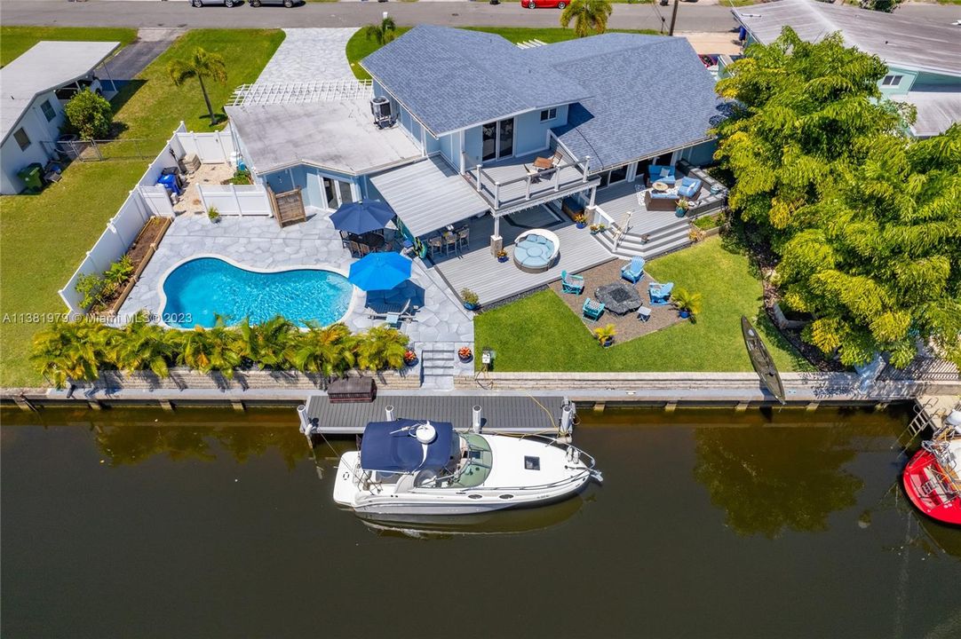 Wonderful Waterfront Pool Home with 31 feet of new bumbers on dock.  Perfect entertainment home with fire pit seating area and roof top entertainment deck.