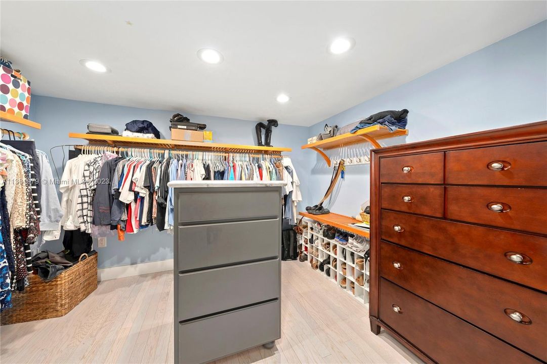 What a treat and suprise!  John Lewis Home Mahogany Closet System.  Ample closet space.  When in the closet and the solid core pocket doors are closed, there are mirror on the closet doors for your convenience.