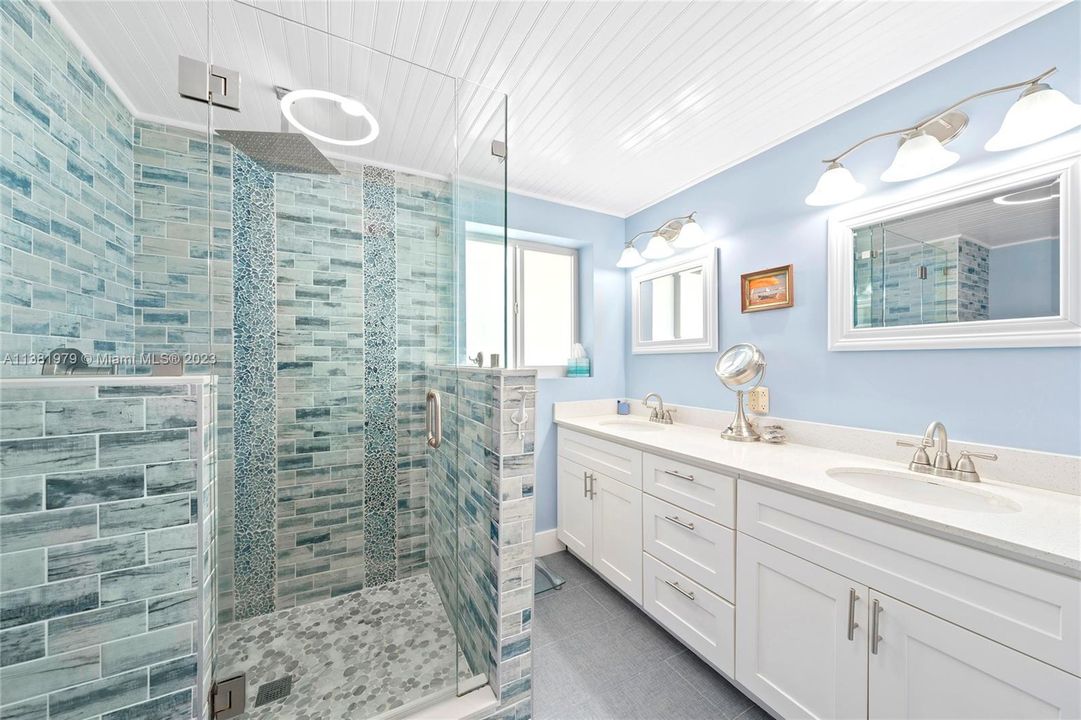 In-suite master bath with double sinks and fun beach themed colored tiles.  Speaker-lights in all three bathrooms for musical enjoyment.  The tankless water heater for your convenience in showering and bathing.