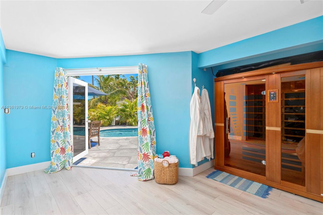 Featuring the 4th bedroom (legally converted from carport) featuring the Infrared Sauna and quick access direclty to the pool with pool shower out and to the right.  Inside the 4th bedroom is the 3rd bathroom featured next.