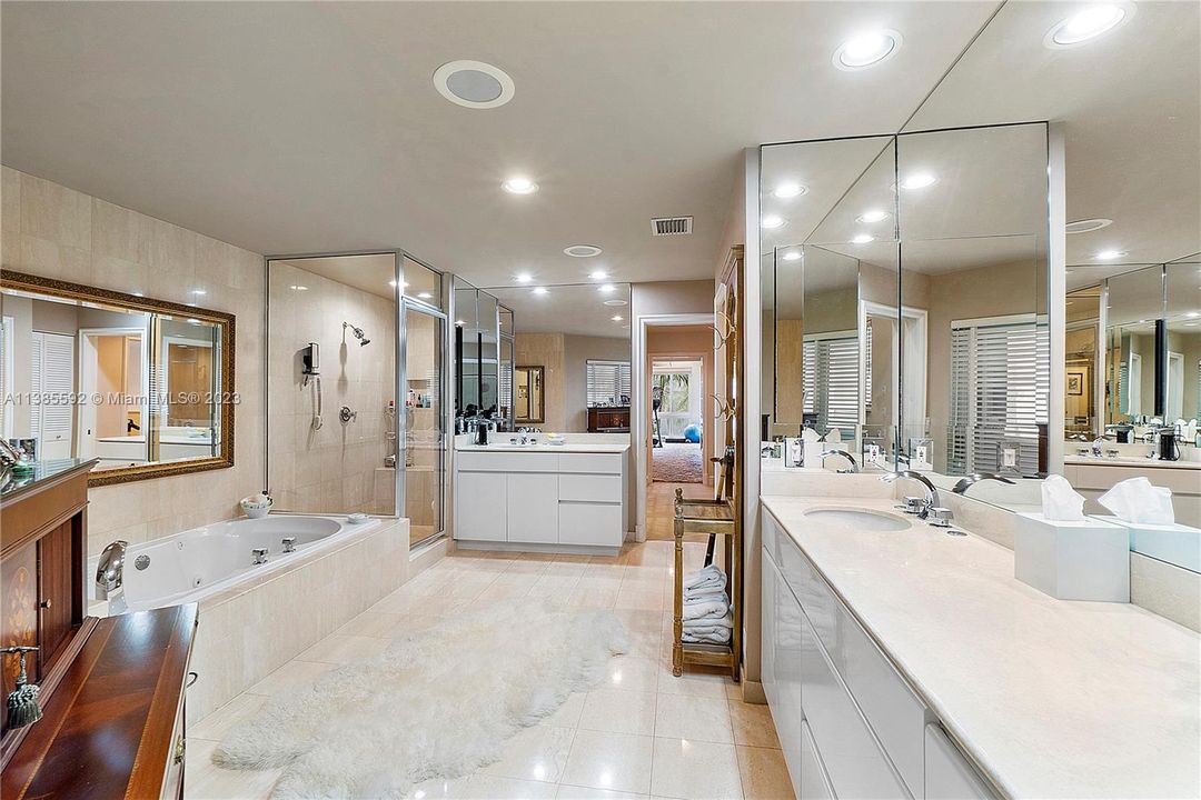 Primary bathroom with double vanities and sinks, Jacuzzi Tub, Steam Shower and privacy water closet.