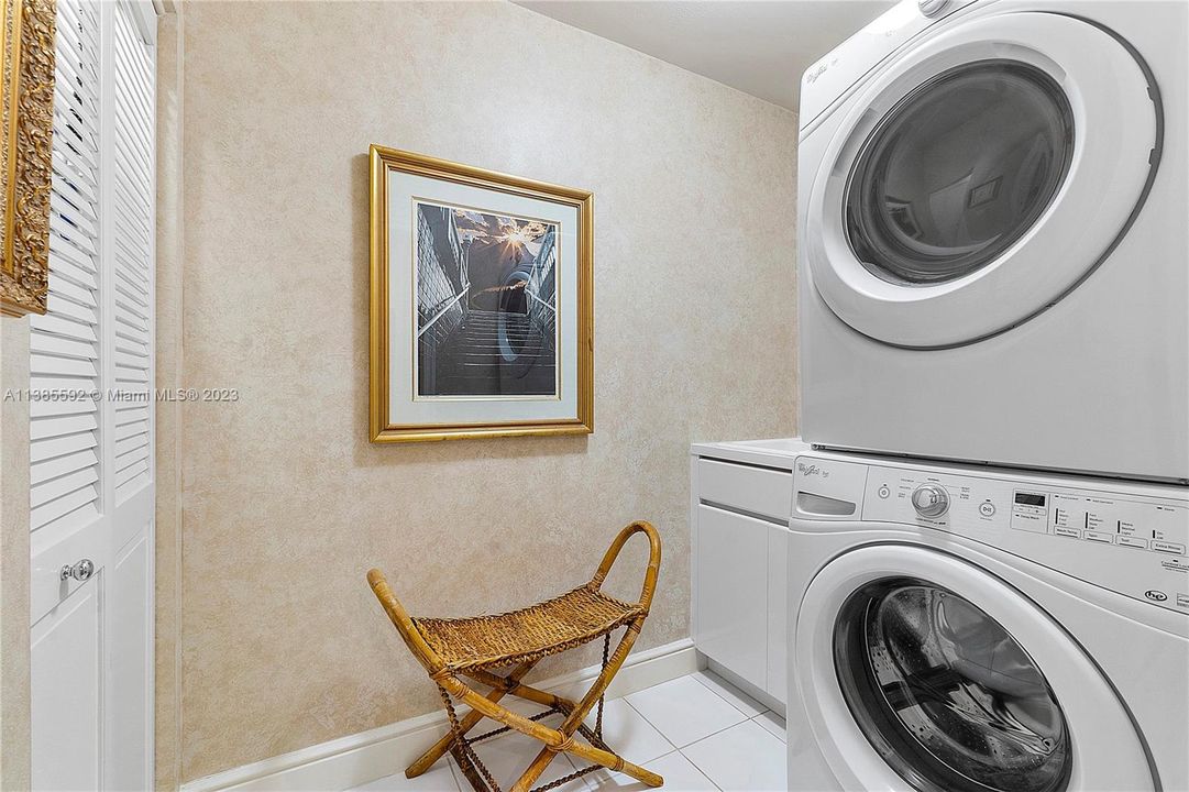 Full Size Laundry Room with sink, large closet and stacked washer and dryer