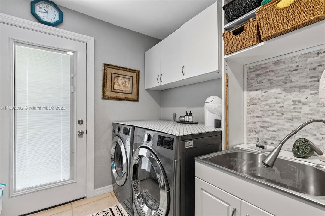 laundry room with sink and storage