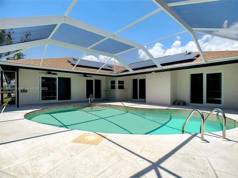 Screened in pool area. Shows the view access from inside the home from dining, kitchen, family and 2 bedrooms.