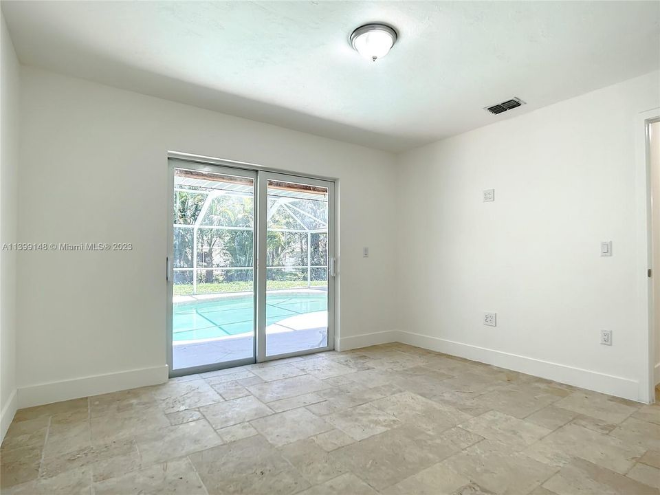 Second bedroom with pool area access.