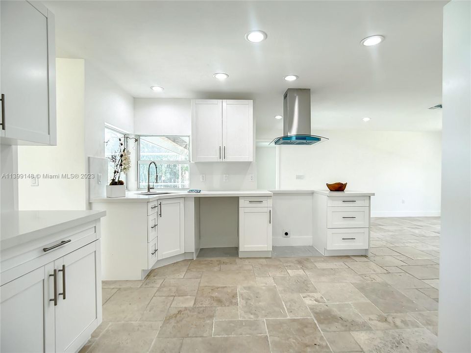 Additional kitchen area view shows impact corner windows access to lots of natural light and pool view.