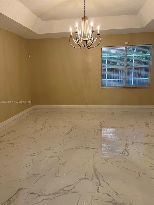 Master bedroom downstairs with ample windows and view of the pool