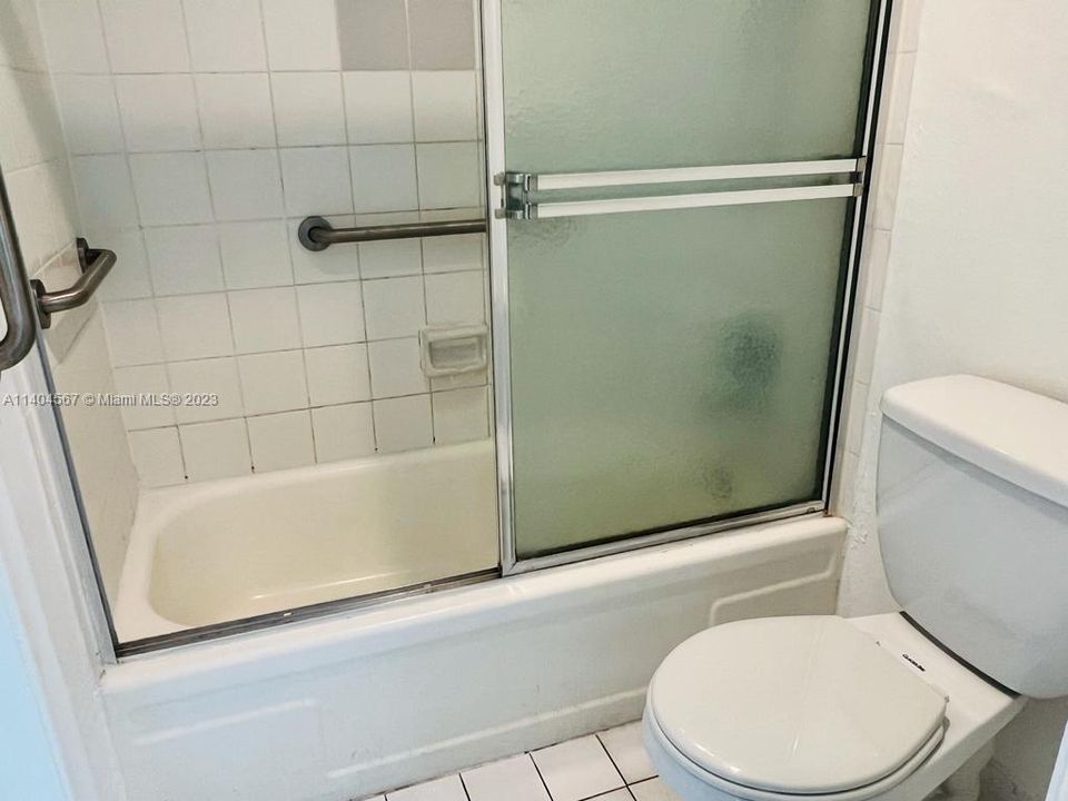 Shower with glass doors joins both bathrooms together